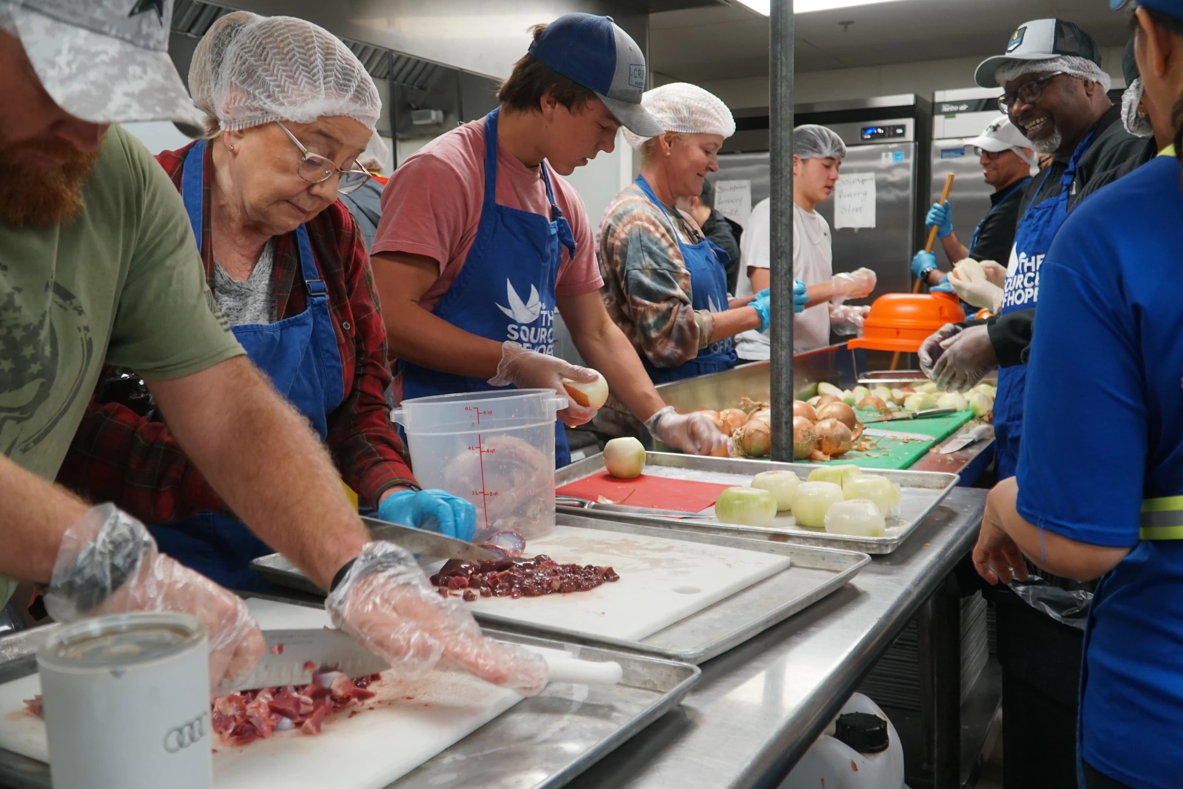 People cooking food at Serving Hope Event