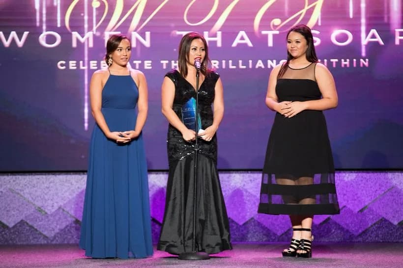 Accepting the Community Outreach Award on stage